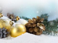 Goudkleurige kerstballen en een dennenappel