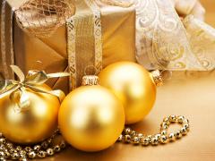 Goudkleurige kerstballen bij een kerstcadeau
